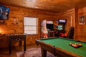 A wooden room with a pool table, foosball table, arcade games, and a Star Wars poster. - Sleeps 10, Game Room, Arcade, Hot Tub, Mountain Views, 6 Mi to Dollywood (Sevierville)