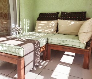 A room with a bed, two nightstands, a window with curtains, and a wall with a textured pattern. - Ascona Vacation Rental 200 meters from Lake Maggiore (Ascona)