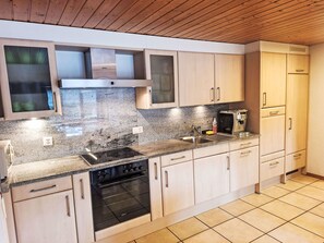 A modern kitchen with a Bosch stove, granite countertop, and light wood cabinets. - La ferme du sommet de Pouillerel by Interhome (La Chaux-de-Fonds)