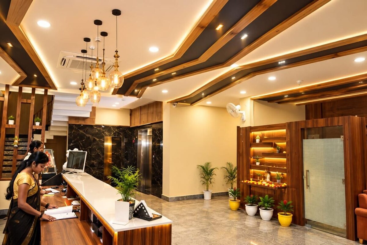 A reception area with a reception desk, a computer, and a wall-mounted fan.