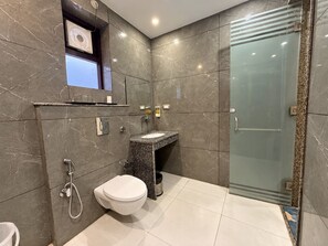 A modern bathroom with a toilet, sink, and shower. - The Abhyudyam Ganga (Haridwar)