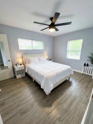 A bedroom with a bed, nightstands, a ceiling fan, and windows. - Private Arcadia-Phoenix Escape with Resort-Style Backyard (Phoenix)
