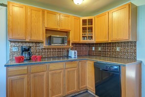 A kitchen with wooden cabinets, a microwave, a coffee maker, and a dishwasher. - Deck, Large Yard! Country Home in Mount Vision (Mount Vision)