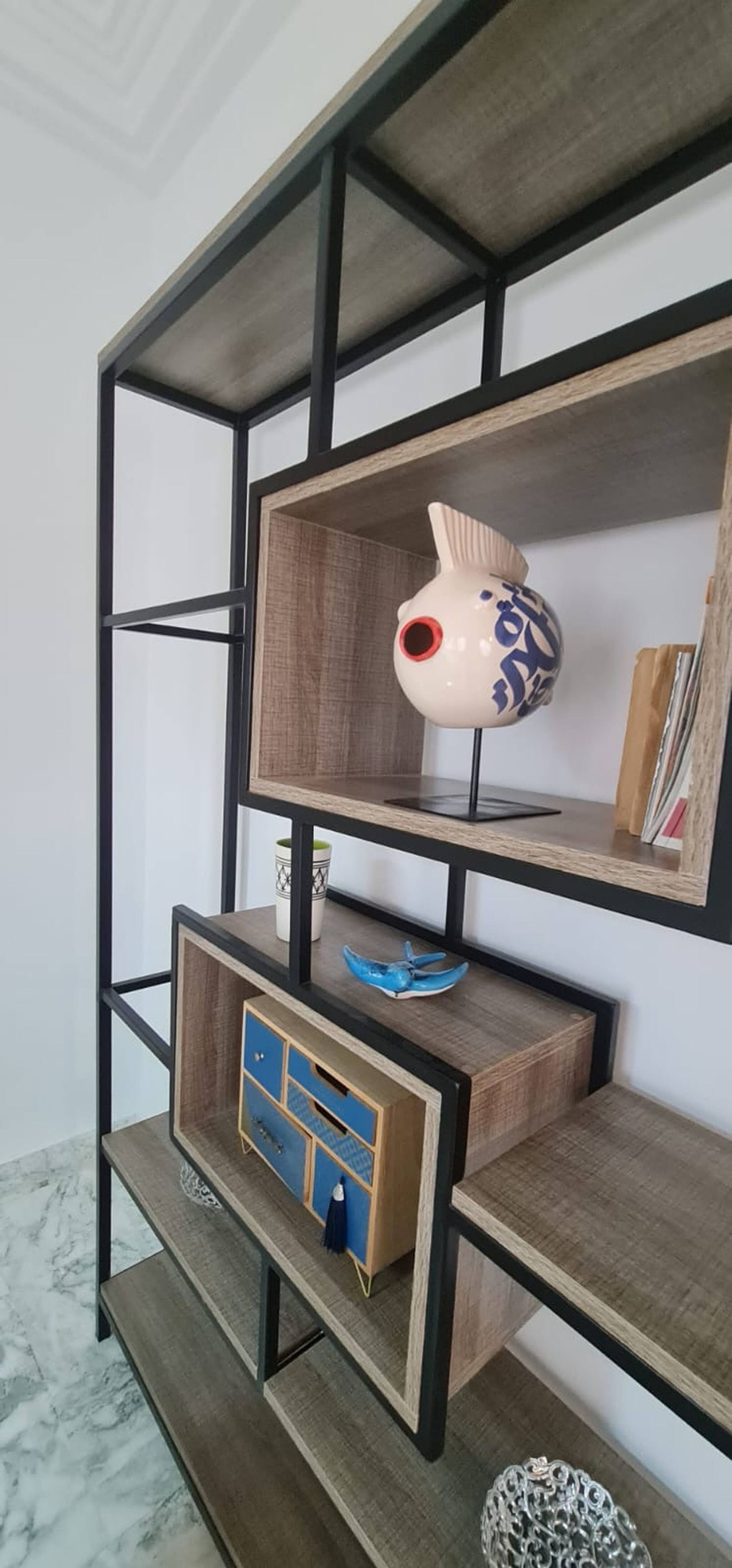 A multi-tiered shelving unit with various decorative items.