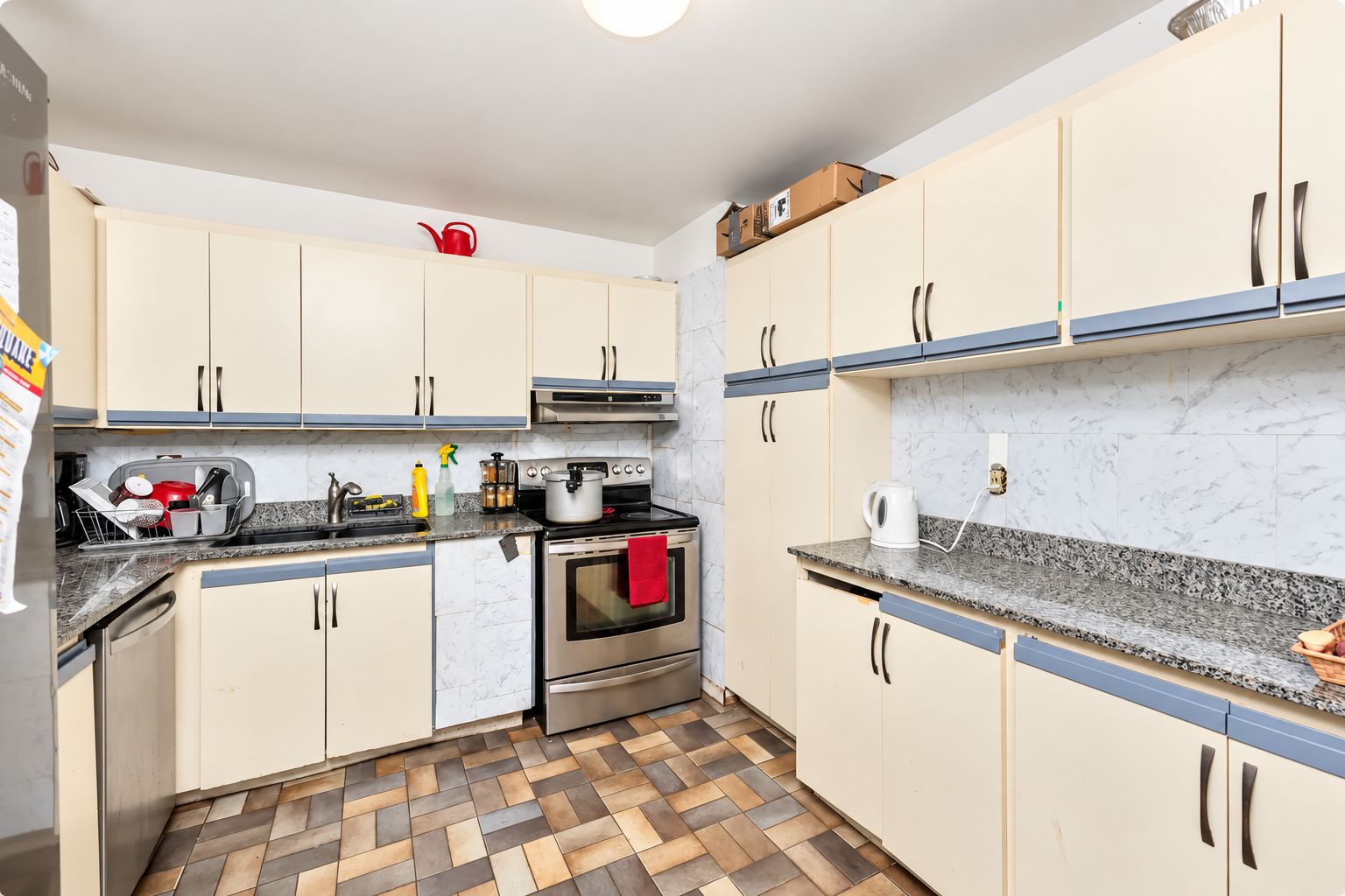 A compact kitchen with a stove, oven, and countertop appliances.