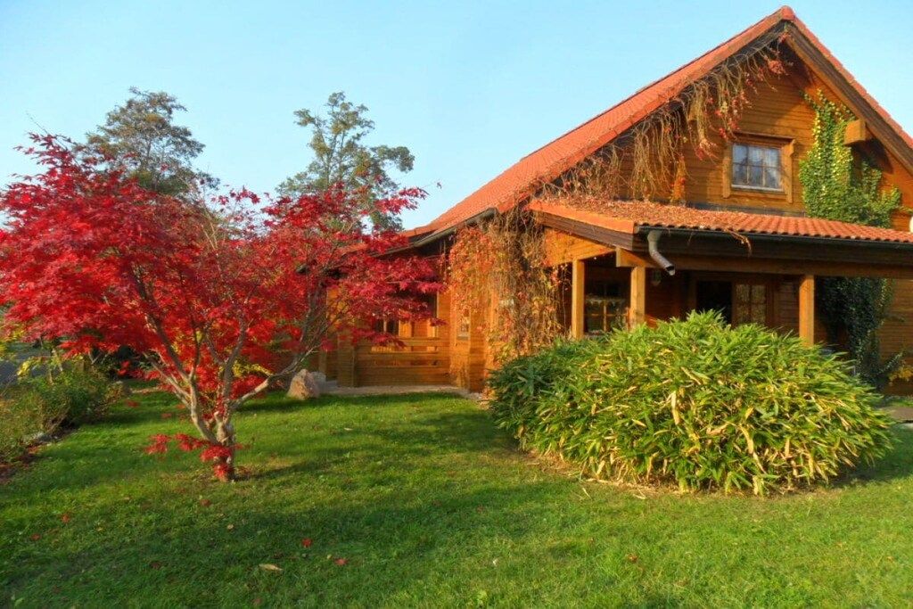 A wooden house with a sloped roof and a front porch.