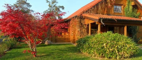A wooden house with a sloped roof and a front porch.