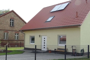 A two-story building with a red-tiled roof, a small porch, and a fenced yard. - "Little brother"||Schönefeld (Schönefeld)