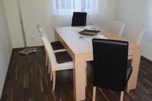 A dining area with a table, chairs, and a floor lamp. - "Little brother"||Schönefeld (Schönefeld)