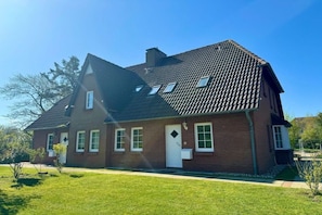 A two-story house with a sloped roof, a front door, and a small front yard. - Holiday home in Wyk on Föhr with terrace (Wyk auf Föhr)