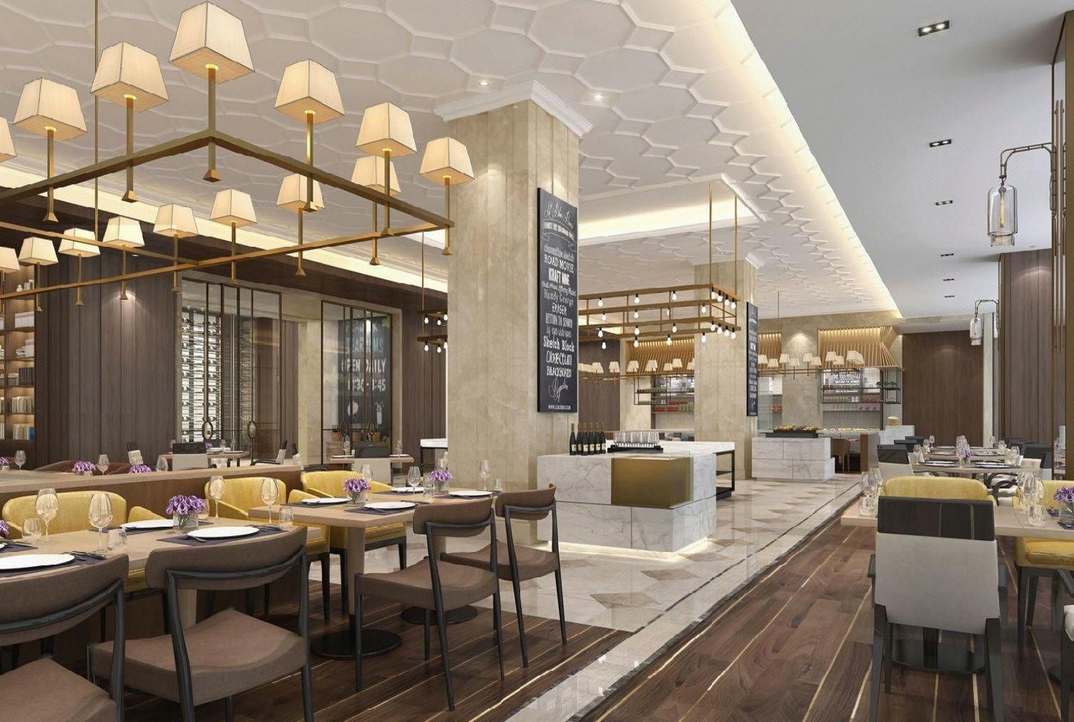 A modern restaurant interior with multiple dining tables, chairs, and pendant lighting.
