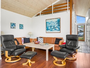 A modern living room with a wooden ceiling, a sofa set, a coffee table, and artwork on the walls. - "Thiokk" - 1.5km from the sea by Interhome (Ålbæk)