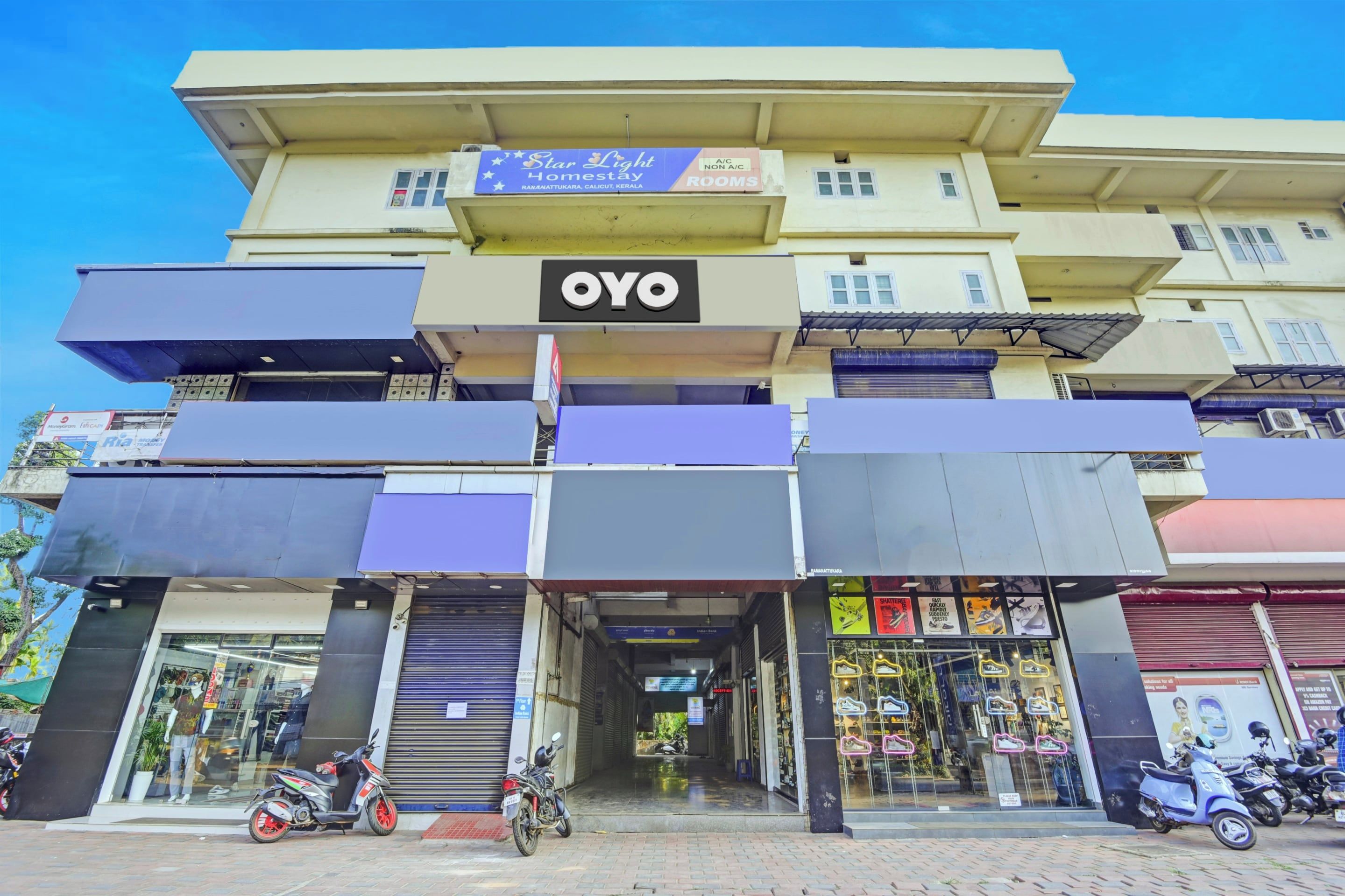 A multi-story building with a prominent 'OYO' sign, indicating it is a hotel.