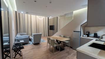 A modern interior with a dining area, kitchen, and seating space.