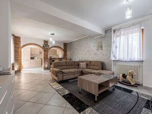 A modern living room with a sectional sofa, a coffee table, and a fireplace. - Cosy apartment for 4 guests with WIFI, A/C, TV and patio (Neive-borgonovo)