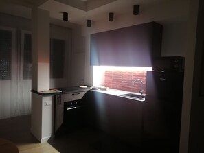 A compact kitchen with a built-in oven, a sink, and a window with a view. - ADRY LIVING ART - A Curated Stay in Palermo (Palermo)