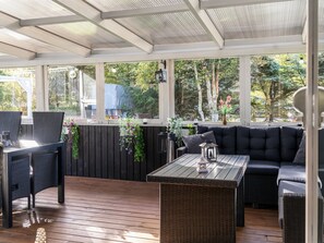 A covered outdoor seating area with a table, chairs, and a sofa. - "Ømunde" - 2.5km from the sea by Interhome (Blokhus)