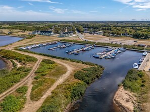 A marina with multiple docks and boats, surrounded by greenery and a clear sky. - "Zuhra" - 50m to the fjord by Interhome (Tarm)