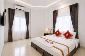 A hotel room with a large bed, a flat-screen TV mounted on the wall, and an air conditioning unit. - The Rice Hotel 121 Bui Vien (Ho Chi Minh City)