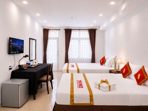 A hotel room with two beds, a desk with a computer, a refrigerator, and a television on the wall. - The Rice Hotel 121 Bui Vien (Ho Chi Minh City)