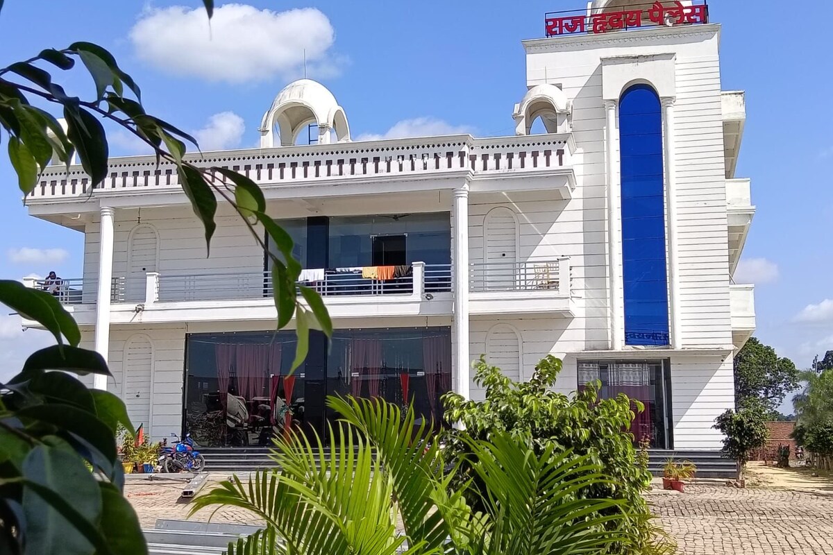 A two-story building with a prominent blue entrance and a sign in a foreign script.