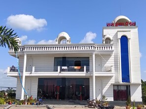 A two-story building with a prominent dome and a blue entrance door. - Wishotel Resort Rajkumari Hridya Palace  (Padri Gajarat)