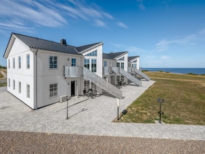 A modern two-story house with a paved driveway and a grassy lawn. - "Apsolon" - 50m to the fjord by Interhome (Tarm)
