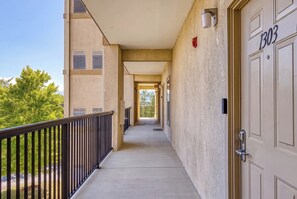 A corridor with a balcony, doors, and a view of trees. - Cozy Pigeon Forge Condo | Mountain Views, Resort Pools & Near Dollywood (Pigeon Forge)