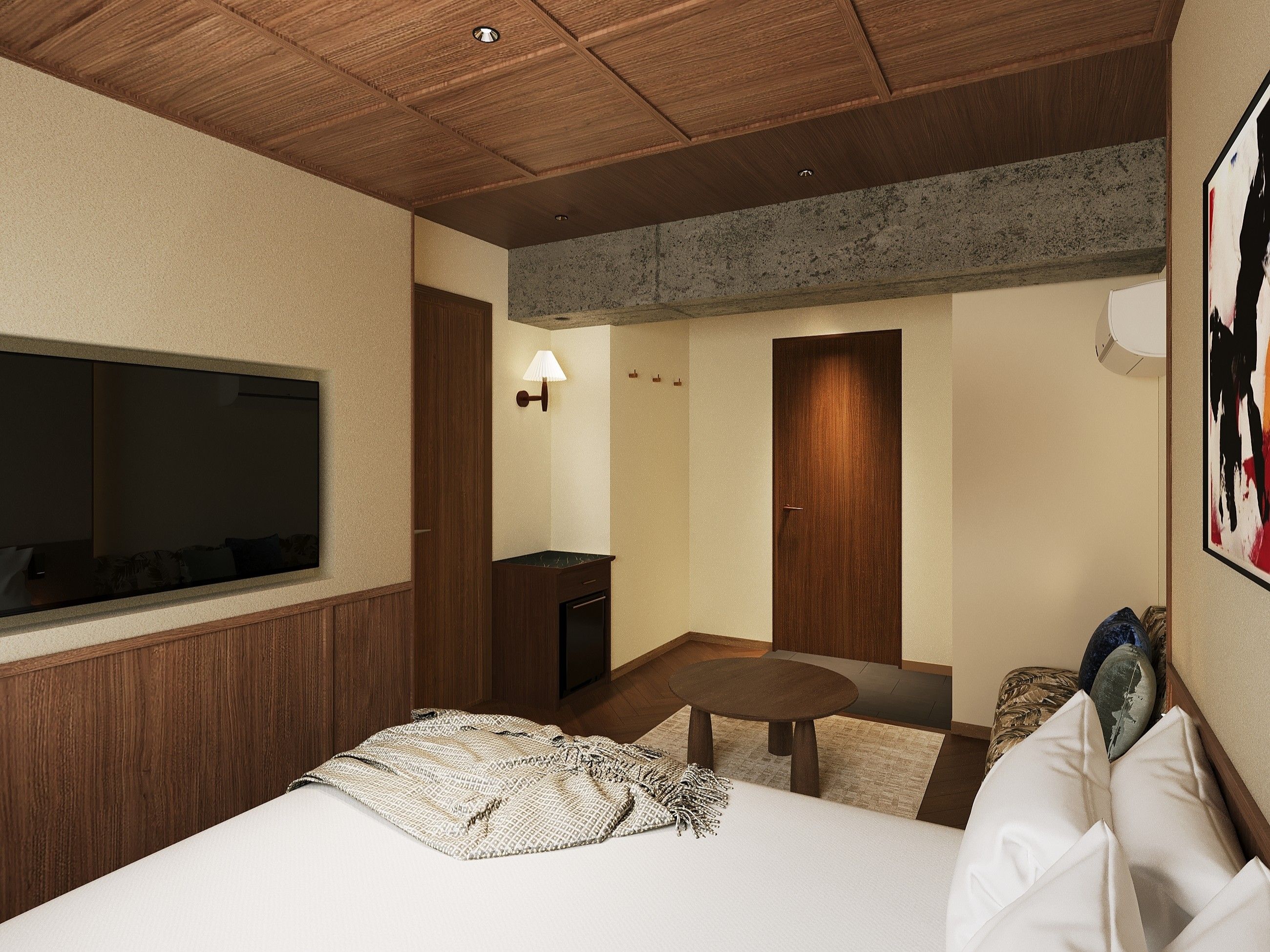 A hotel room with a large bed, a television mounted on the wall, a small table, and a door.