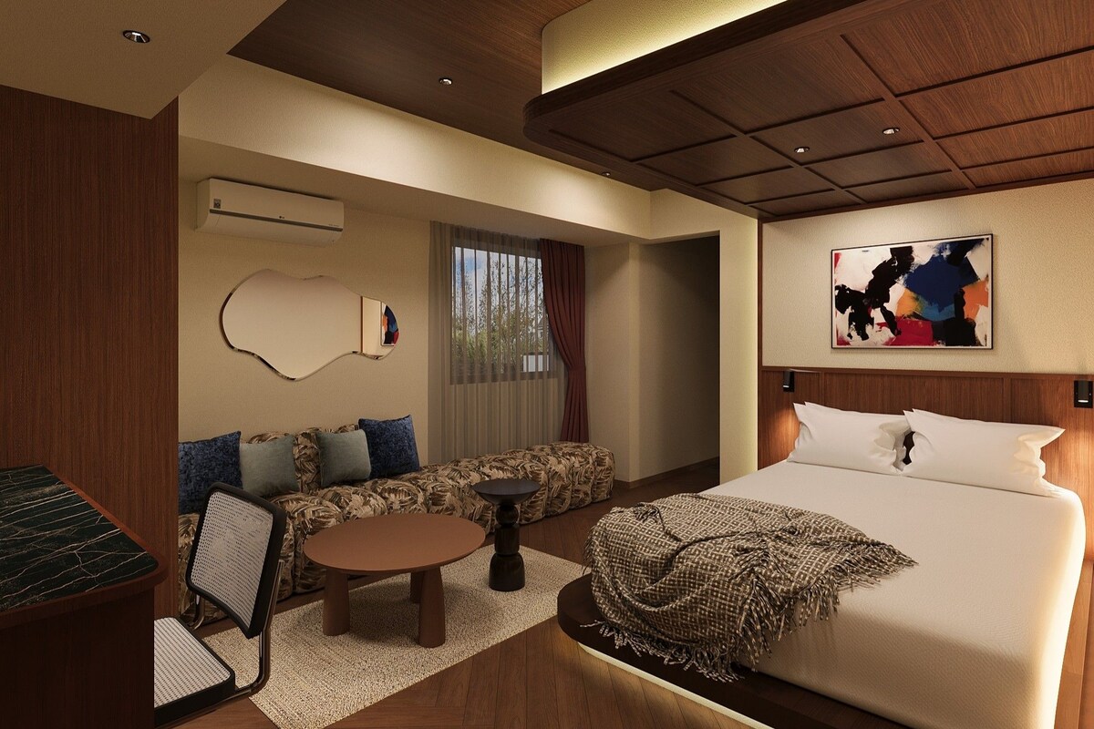 Une chambre d’hôtel moderne équipée d’un lit, d’un canapé et d’un coin repas.