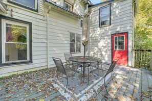 A covered patio with a table and chairs, surrounded by a deck with fallen leaves. - Cozy B&B Suite Near Finger Lakes & State Parks (Interlaken)