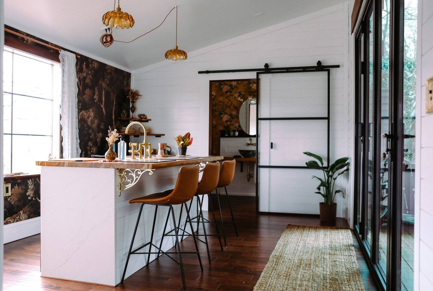 Designer kitchen with waterfall island, brass details, and chic modern style