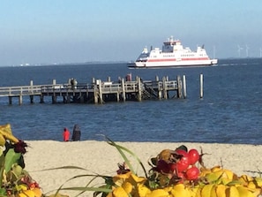 A pier extending into a body of water with a ferry in the distance. - Holiday Apartment in Wrixum With Terrace (Wrixum)