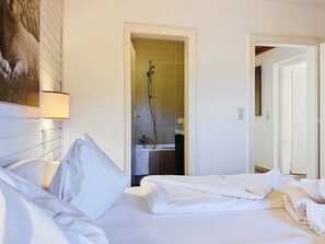 A hotel room with a bed, a shower, and a bathroom. - Hundstein am See by Interhome (Zell am See)