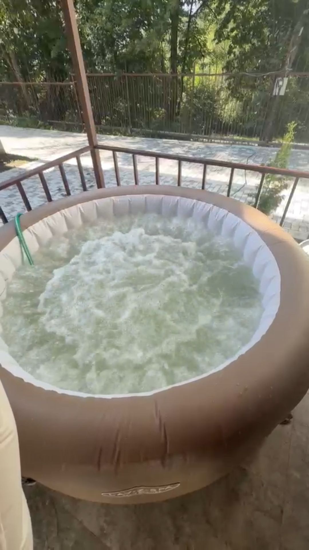A hot tub with a circular shape and a visible brand name on the side.