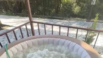 A hot tub with a circular shape and a visible brand name on the side.