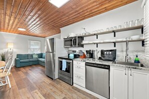 A modern kitchen with stainless steel appliances, a built-in oven, and a dishwasher. - Sea Star One Block to the Beach Top Location (North Myrtle Beach)
