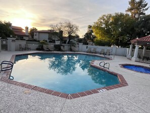 A swimming pool with a tiled deck, lounge chairs, and a view of the surrounding buildings. - Quiet Scottsdale location for Snowbirds - near golf, restaurants and more. (Scottsdale)