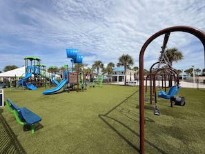 A playground with various play structures and a swing set. - Windsor Island 5BR with Pool & Waterpark (Davenport)