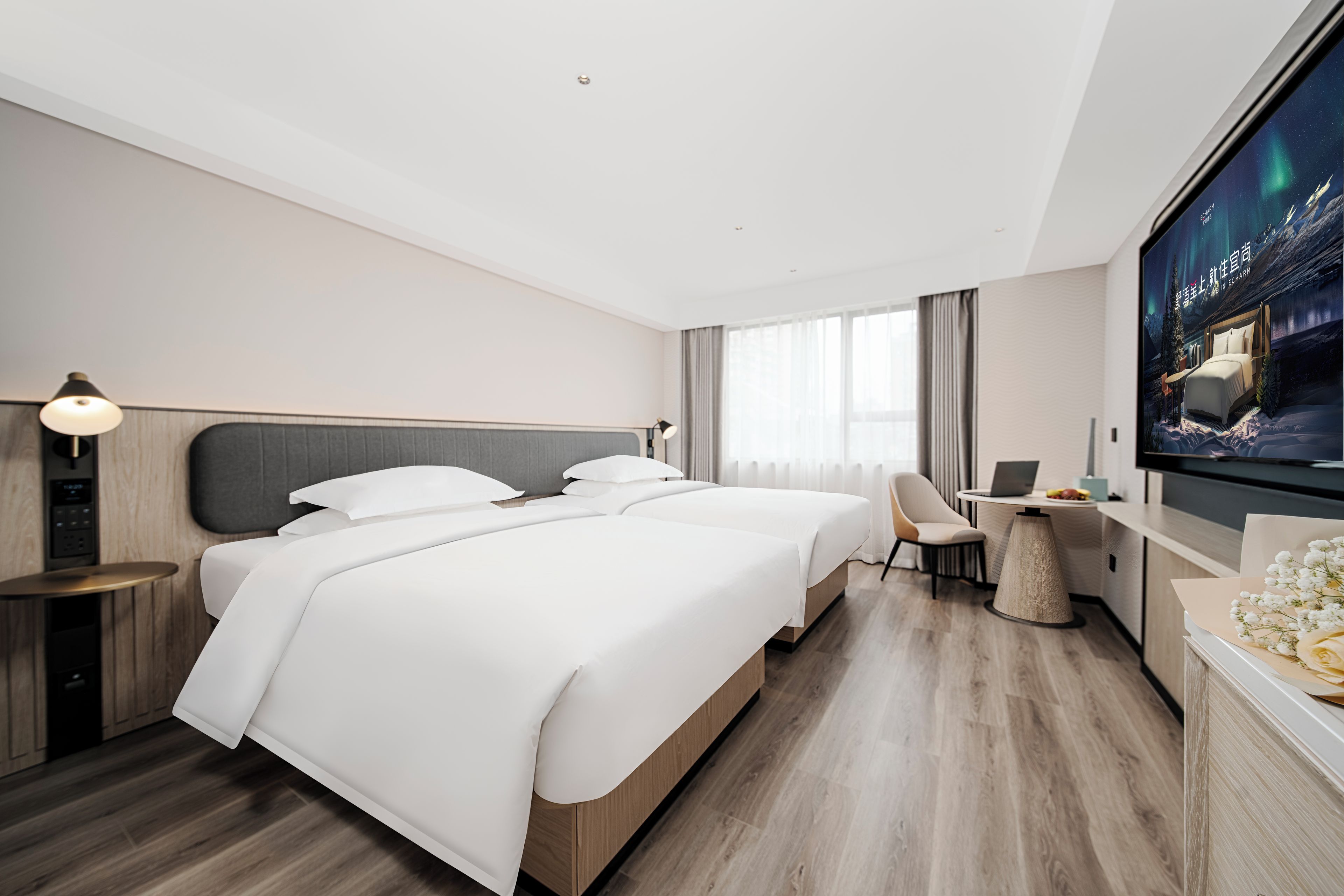 A modern hotel room with a large bed, a desk, a chair, a television, and a window with curtains.