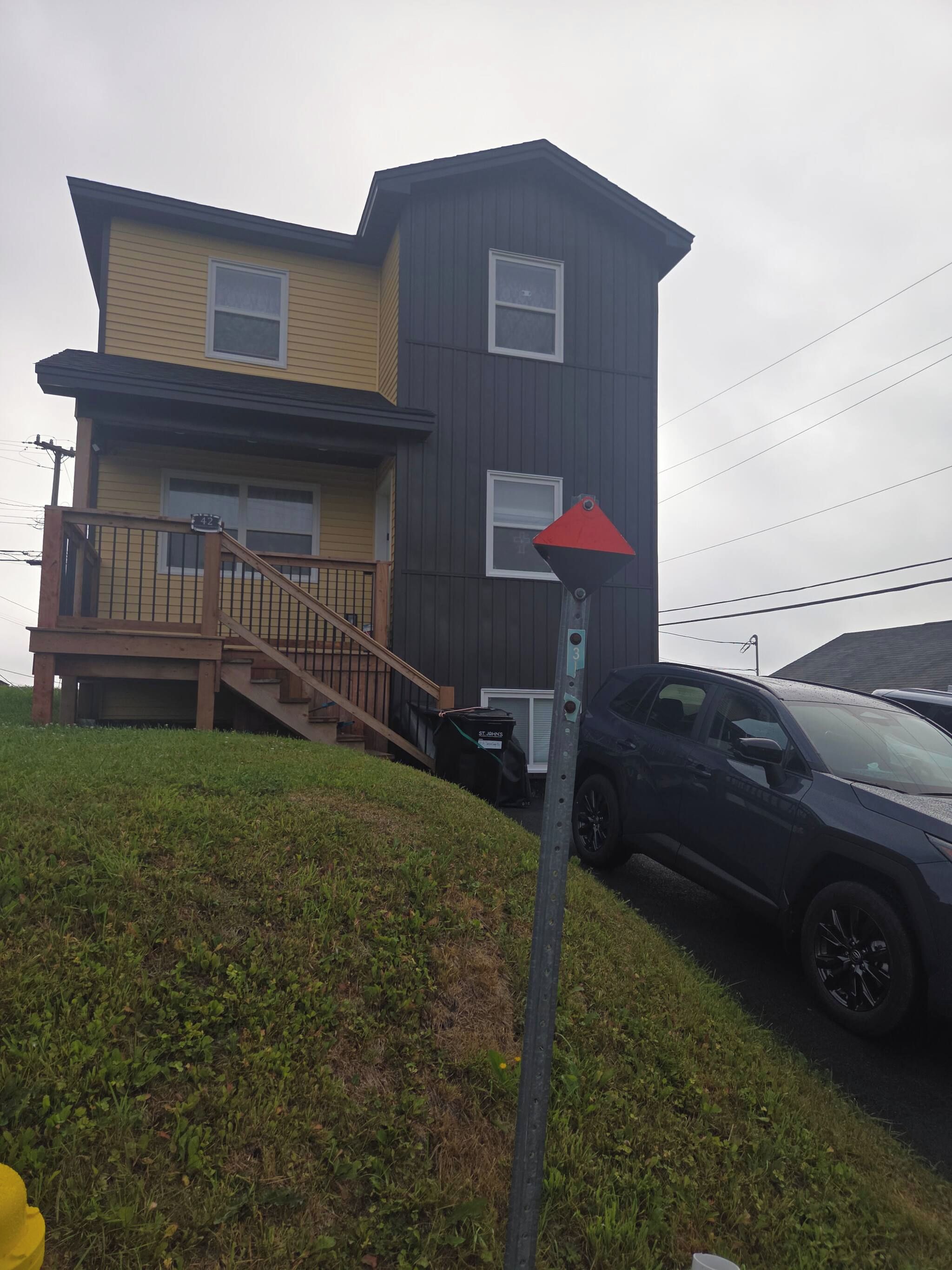 A two-story building with a staircase leading to the upper level.