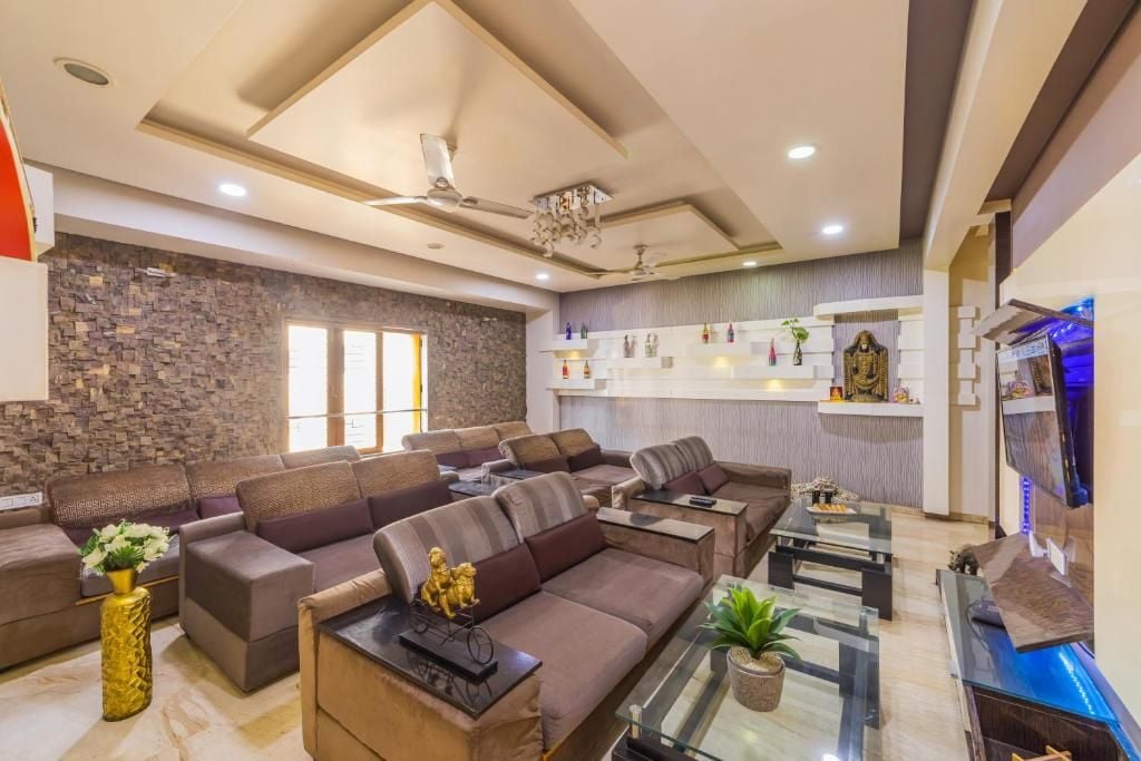 A modern living room with sofas, a coffee table, and a TV.