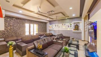 A modern living room with sofas, a coffee table, and a TV.