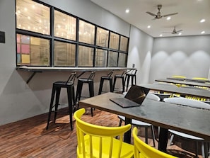 A conference room with a long table, multiple chairs, and a laptop on the table.