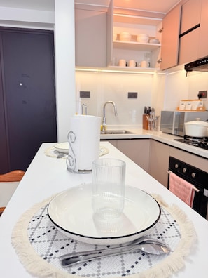 A modern kitchen with a central island, a sink, and a stove. - 2-Bedroom Westlands Two Balconies Next To Foodplus And Artcaffe Rhapta Road (Nairobi)