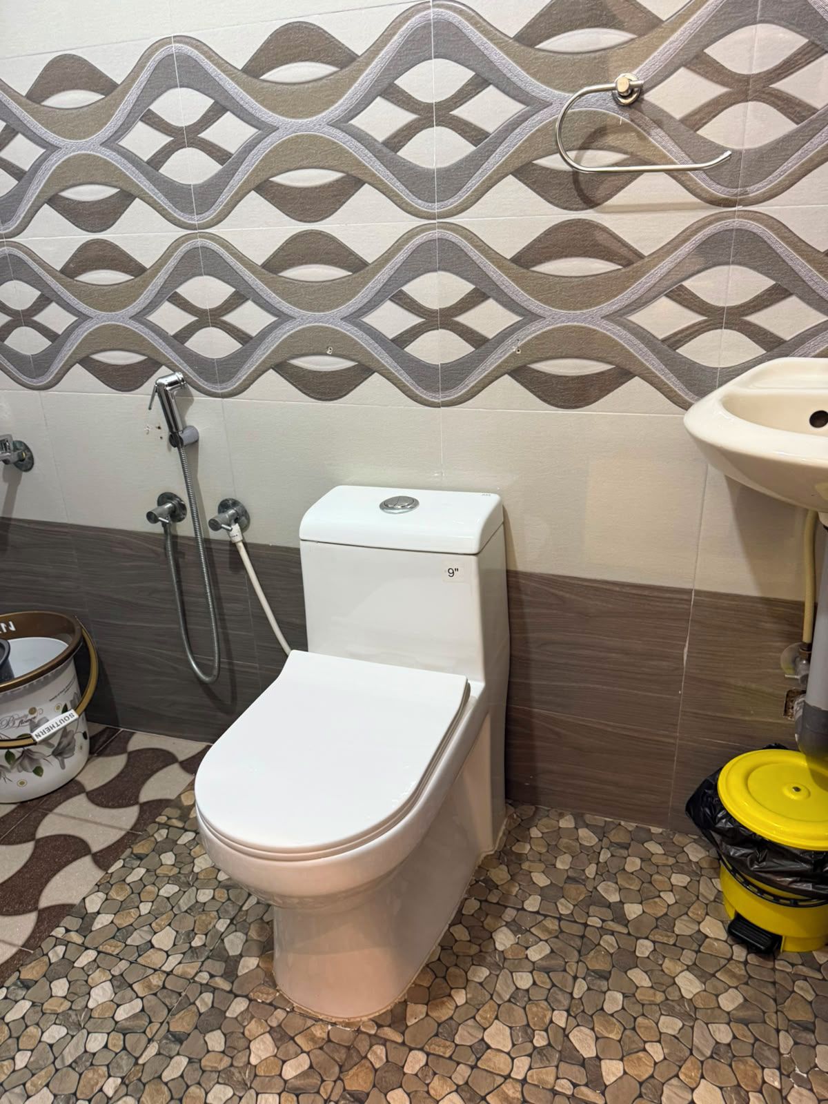 Une salle de bain avec des toilettes, une douche et un lavabo.