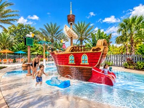 A water park with a pirate ship play structure, a pool, and palm trees. - Luxurious Retreat 3Beds/2Baths with Club Access (Davenport)