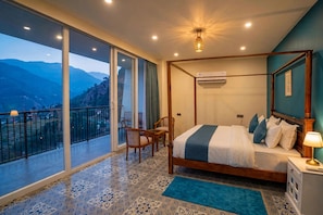 A four-poster bed with a view of mountains through large sliding doors. - Raj Villas by Jomotel, Riverside Retreat (Palach)