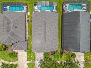 A residential area with three large buildings, each with a swimming pool. - 5BR Family Fun Home | Game Room & Private Pool (Kissimmee)