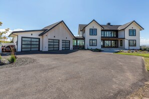 A two-story house with a large driveway and a garage. - Large home with breathtaking views in Bozeman's most exclusive neighborhood. (Bozeman)